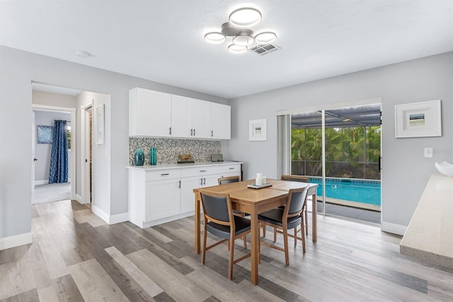 dining area featuring baseboards, visible vents, and light wood-style floors