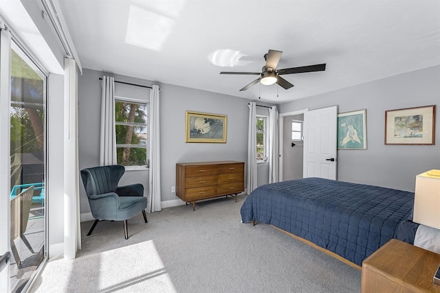 carpeted bedroom featuring access to outside, baseboards, and a ceiling fan