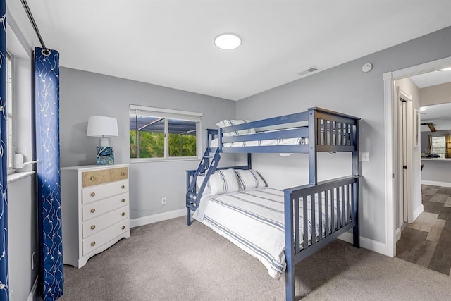 bedroom with carpet flooring, visible vents, and baseboards