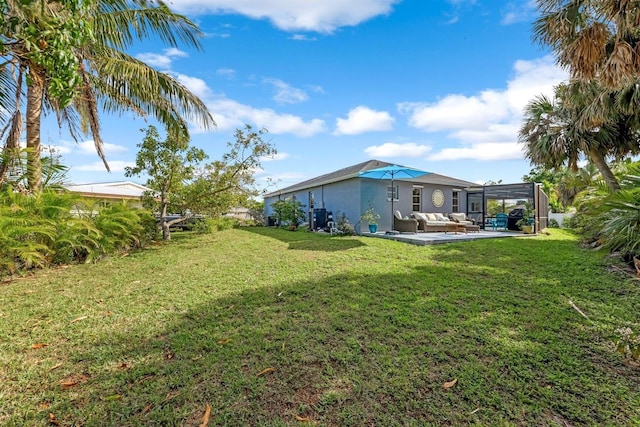 view of yard with a lanai, a patio, and an outdoor living space