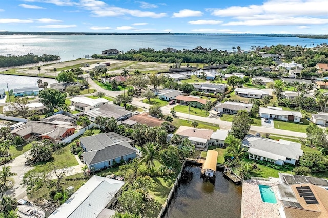 drone / aerial view with a water view and a residential view