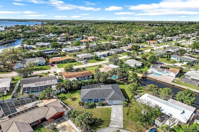 drone / aerial view with a residential view and a water view