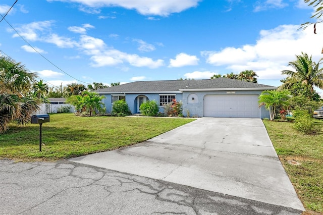 ranch-style home with a garage, concrete driveway, a front yard, and stucco siding