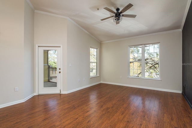 empty room with lofted ceiling, baseboards, wood finished floors, and crown molding