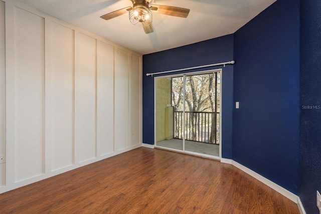 empty room featuring a ceiling fan, baseboards, and wood finished floors