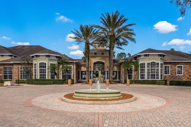 view of building exterior with curved driveway