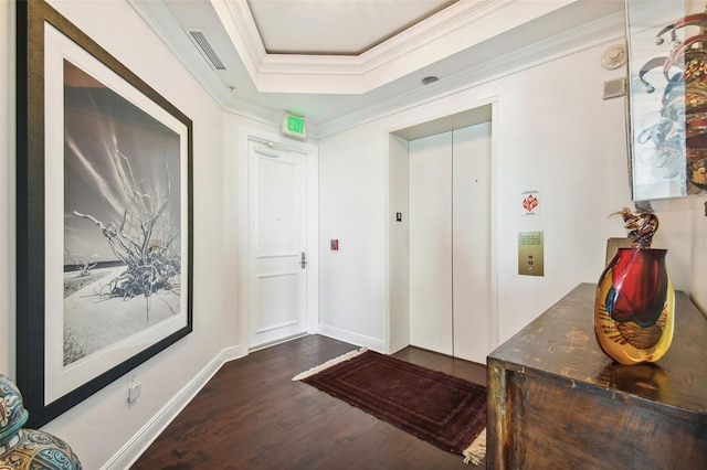 entryway with crown molding, baseboards, dark wood-style floors, a raised ceiling, and elevator