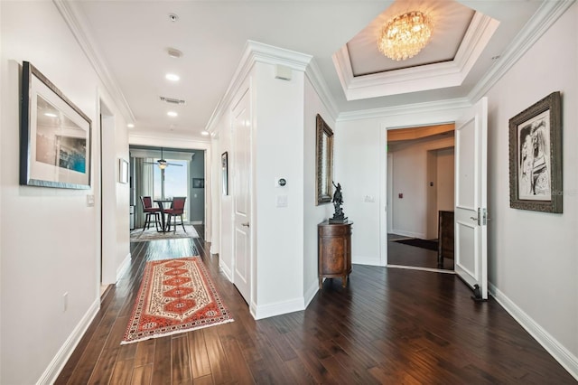 hall with crown molding, baseboards, and hardwood / wood-style flooring