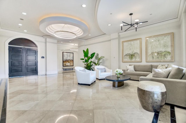 interior space with a chandelier, a raised ceiling, and recessed lighting