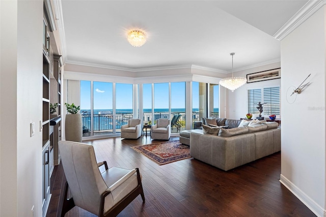 living area featuring baseboards, ornamental molding, dark wood-type flooring, a water view, and a chandelier