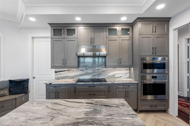 kitchen featuring gray cabinets and exhaust hood