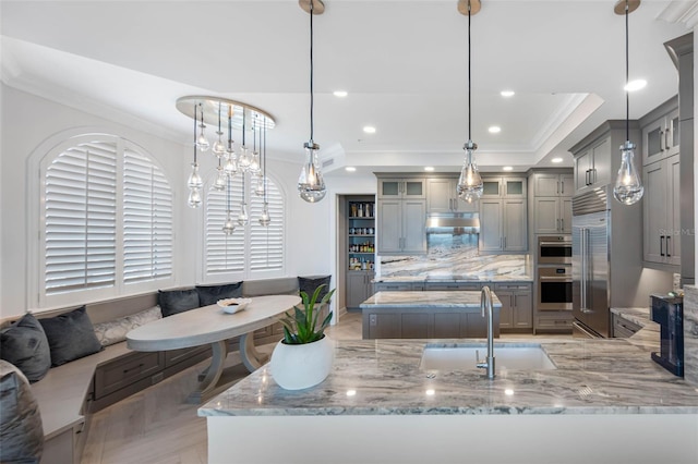 kitchen featuring ornamental molding, breakfast area, and gray cabinets