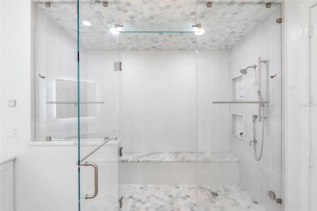 full bath with a shower stall and vanity