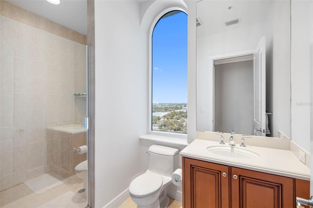 bathroom featuring baseboards, a shower stall, toilet, and vanity