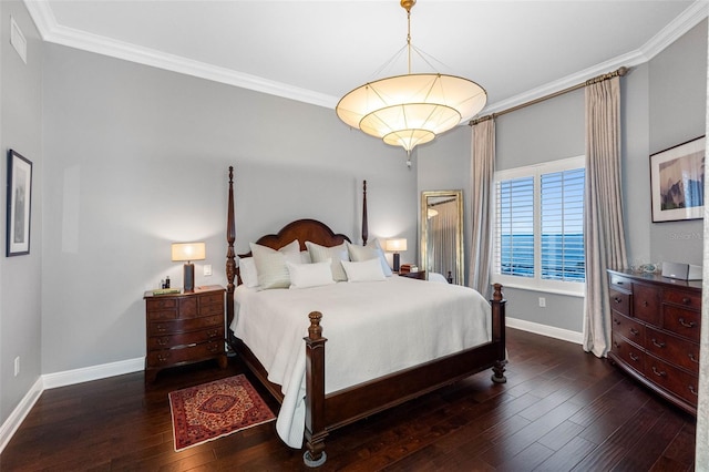 bedroom featuring hardwood / wood-style flooring, baseboards, and crown molding