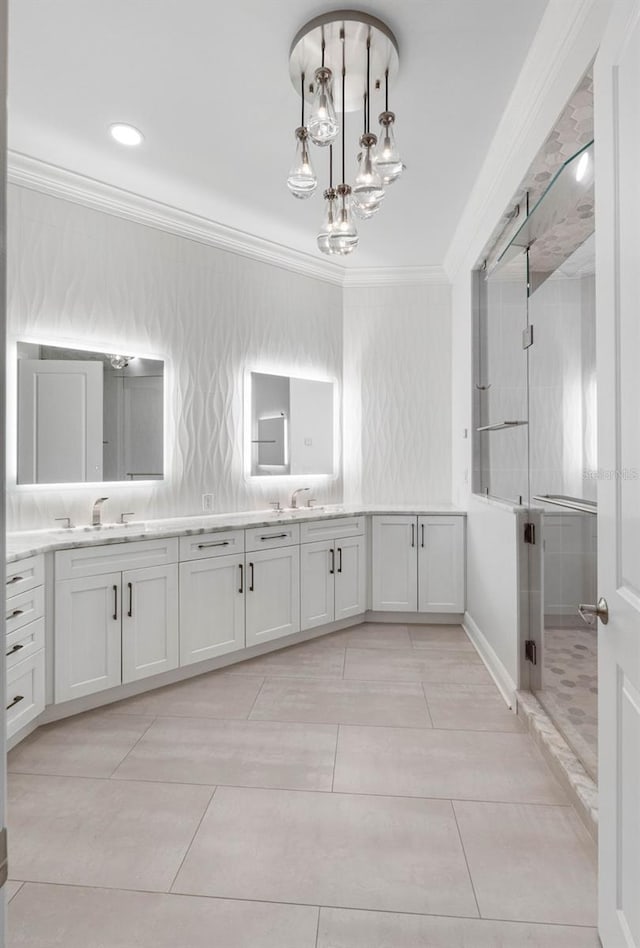 full bath with double vanity, ornamental molding, a stall shower, and a sink