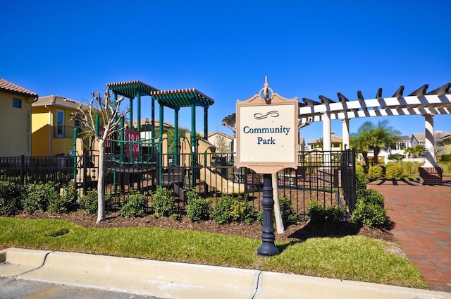 view of home's community featuring a residential view, playground community, and fence