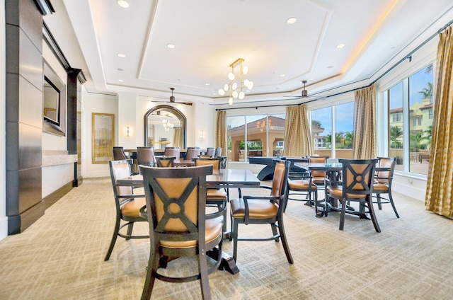 dining space featuring baseboards, recessed lighting, a raised ceiling, and a notable chandelier