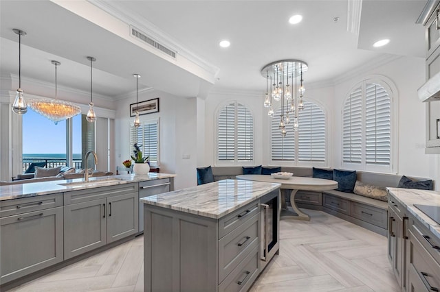 kitchen featuring breakfast area, recessed lighting, gray cabinets, visible vents, and ornamental molding