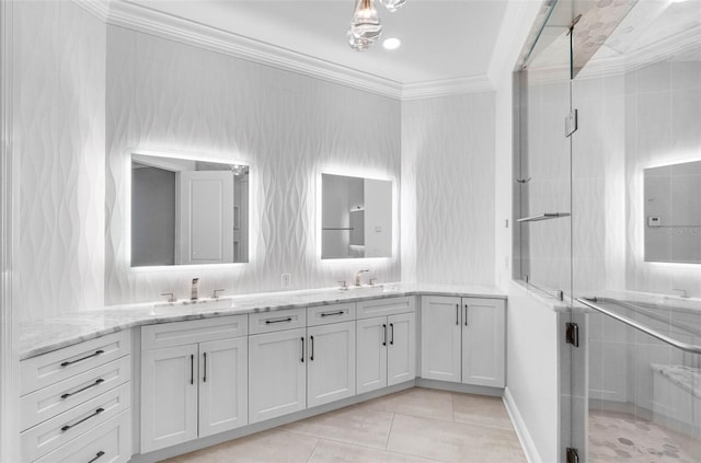 full bathroom featuring a sink, double vanity, ornamental molding, and a shower stall