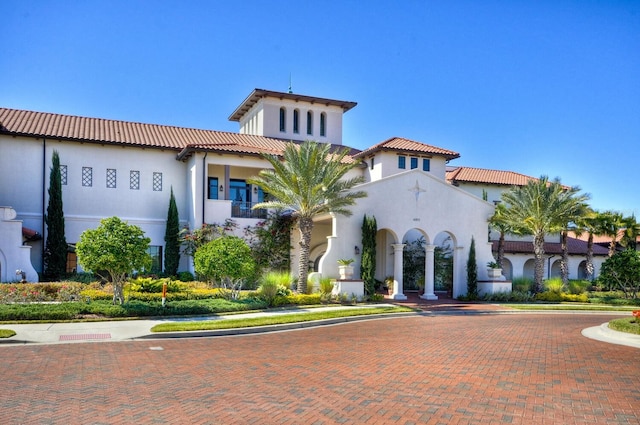 view of front of house featuring a tiled roof and stucco siding