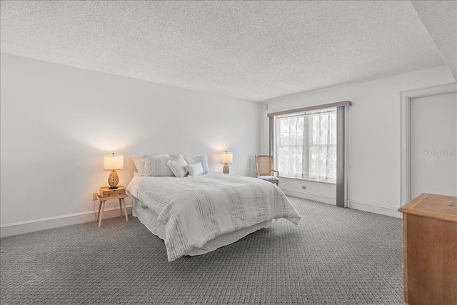 bedroom with a textured ceiling, carpet, and baseboards