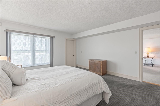 carpeted bedroom featuring baseboards and a textured ceiling