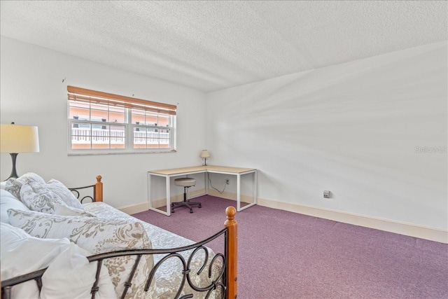 bedroom featuring a textured ceiling, carpet floors, and baseboards