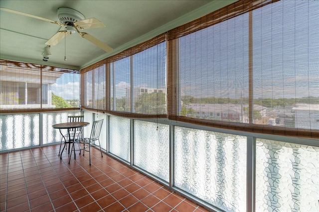 unfurnished sunroom with a ceiling fan