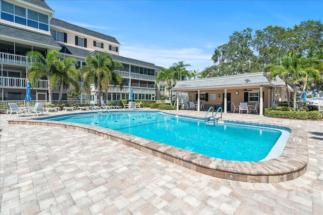 community pool featuring fence and a patio