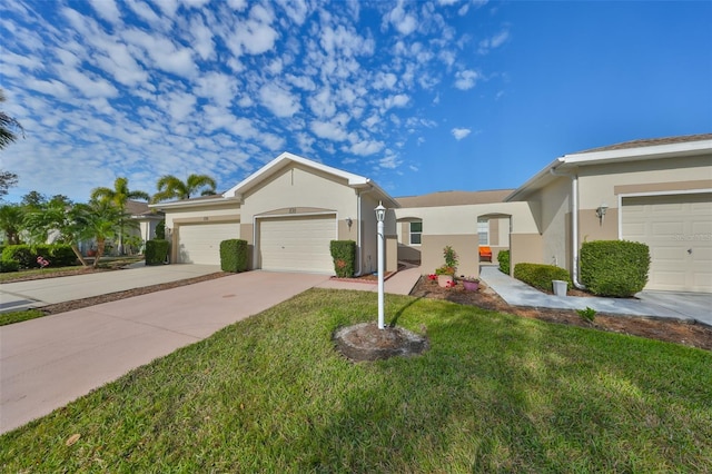 ranch-style house featuring a garage, concrete driveway, a front lawn, and stucco siding