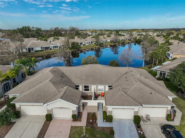 bird's eye view with a residential view and a water view