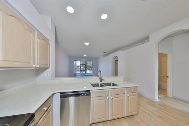 kitchen with a sink, stainless steel dishwasher, and light brown cabinets