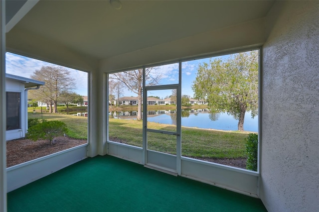 unfurnished sunroom featuring a healthy amount of sunlight and a water view