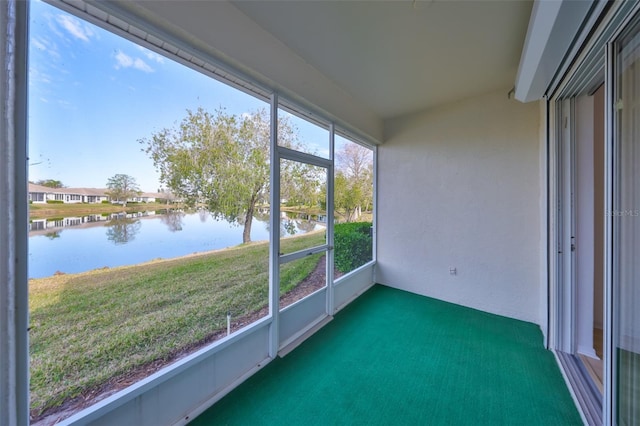 unfurnished sunroom with a water view