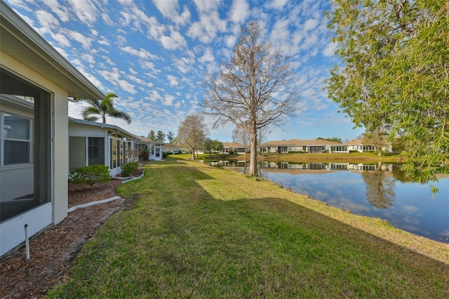 view of yard featuring a water view and a residential view