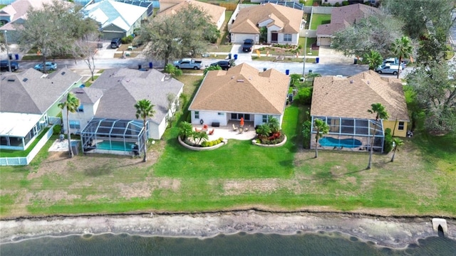 drone / aerial view with a water view and a residential view