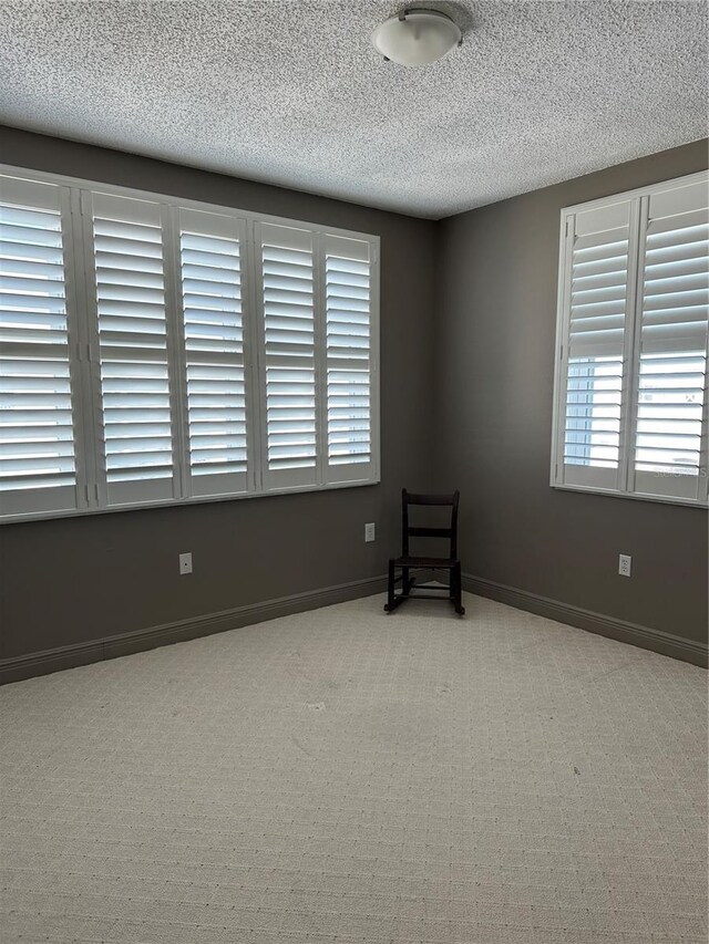 6425 Shoreline Dr Unit 10506, Saint Petersburg, FL 33708 - spare room featuring a textured ceiling and carpet
