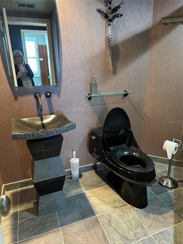 6425 Shoreline Dr Unit 10506, Saint Petersburg, FL 33708 - bathroom with stone finish floors and toilet