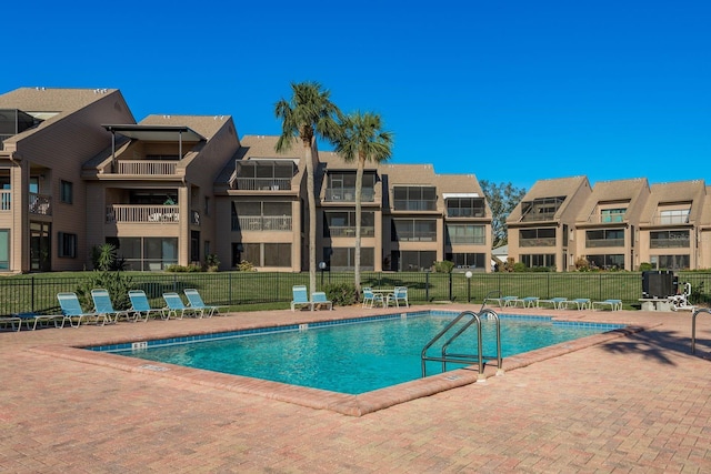 pool featuring fence and a patio