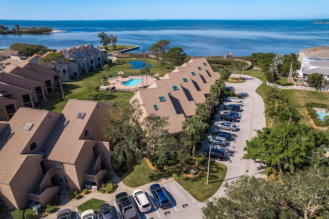 drone / aerial view with a water view and a residential view