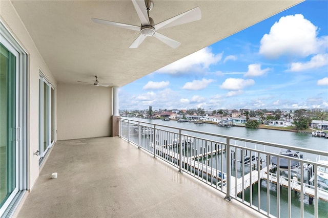 balcony with a water view and ceiling fan