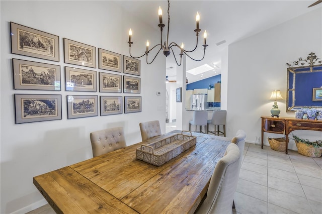 dining room featuring a notable chandelier, lofted ceiling, visible vents, light tile patterned flooring, and baseboards