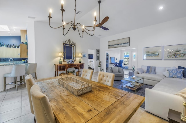 dining area with light tile patterned floors, visible vents, and high vaulted ceiling