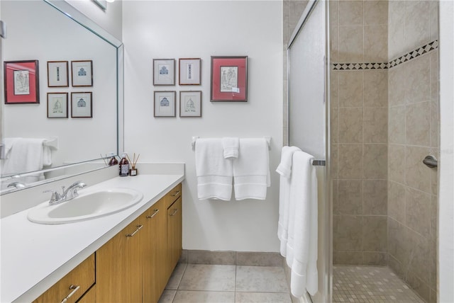 bathroom featuring a stall shower, tile patterned flooring, and vanity