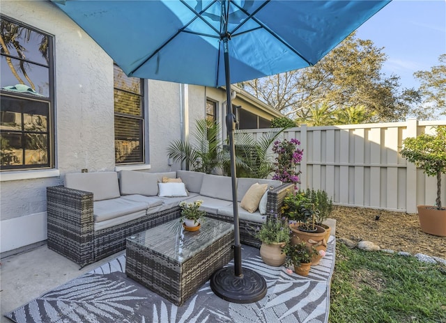 view of patio / terrace with fence and an outdoor living space
