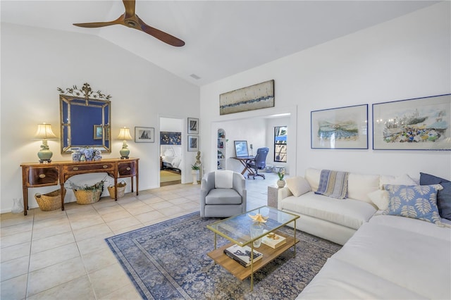 living area with light tile patterned floors, visible vents, baseboards, a ceiling fan, and high vaulted ceiling