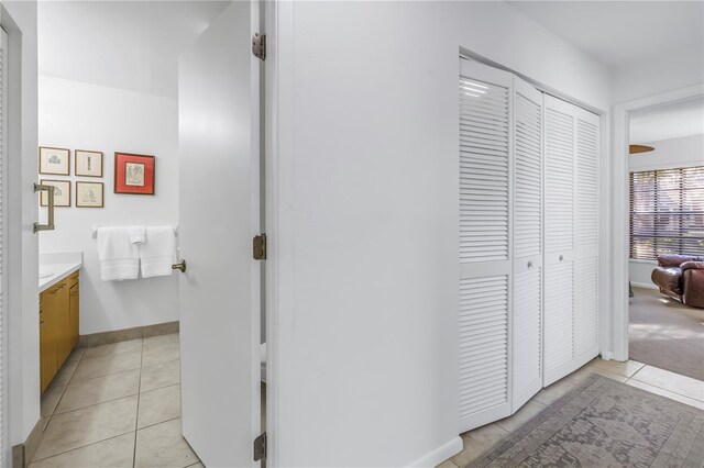 interior space with baseboards and light tile patterned floors