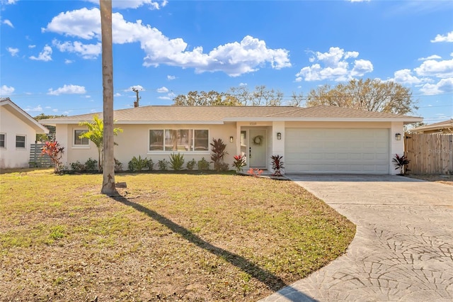 ranch-style home with an attached garage, fence, concrete driveway, stucco siding, and a front lawn