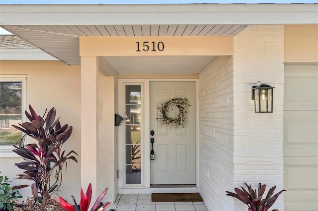 doorway to property with a garage